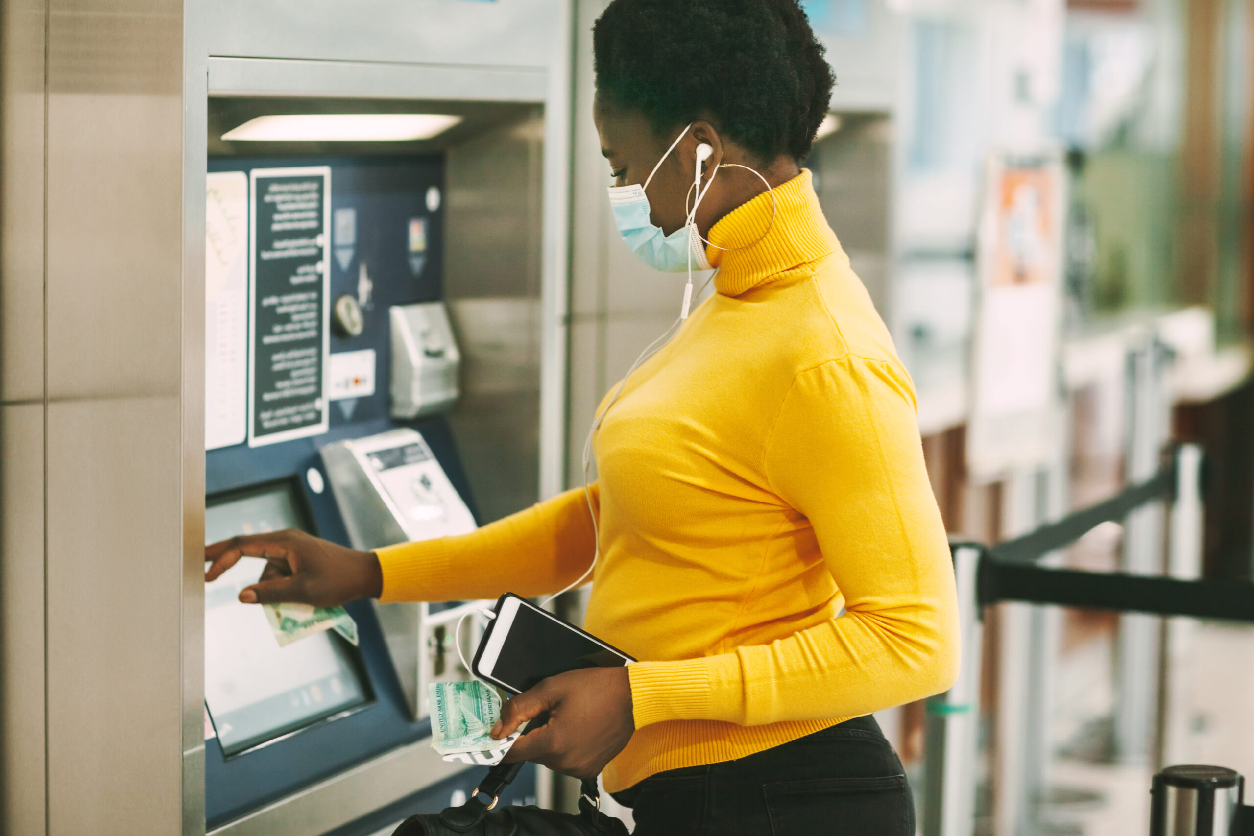 An immigrant getting cash from an ATM